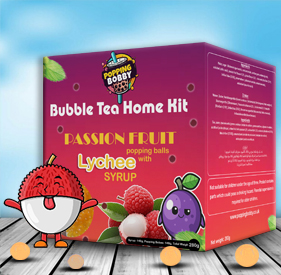 Popping Bobby Bubble Tea Home Kit – Passion Fruit Popping Balls with Lychee Syrup (280g). A pink and purple box featuring fruit characters, passion fruit, lychee, and raspberry images, placed on a wooden surface.