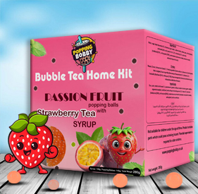 Popping Bobby Passion Fruit Popping Balls with Strawberry Syrup (280g). A vibrant pink box with fruit-themed characters and scattered boba balls on a wooden surface, set against a blue sky background.