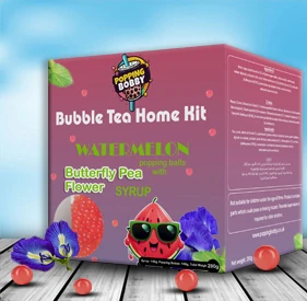 Popping Bobby Bubble Tea Home Kit, 280g edition, with a box and syrup cups containing watermelon popping balls and butterfly pea syrup.